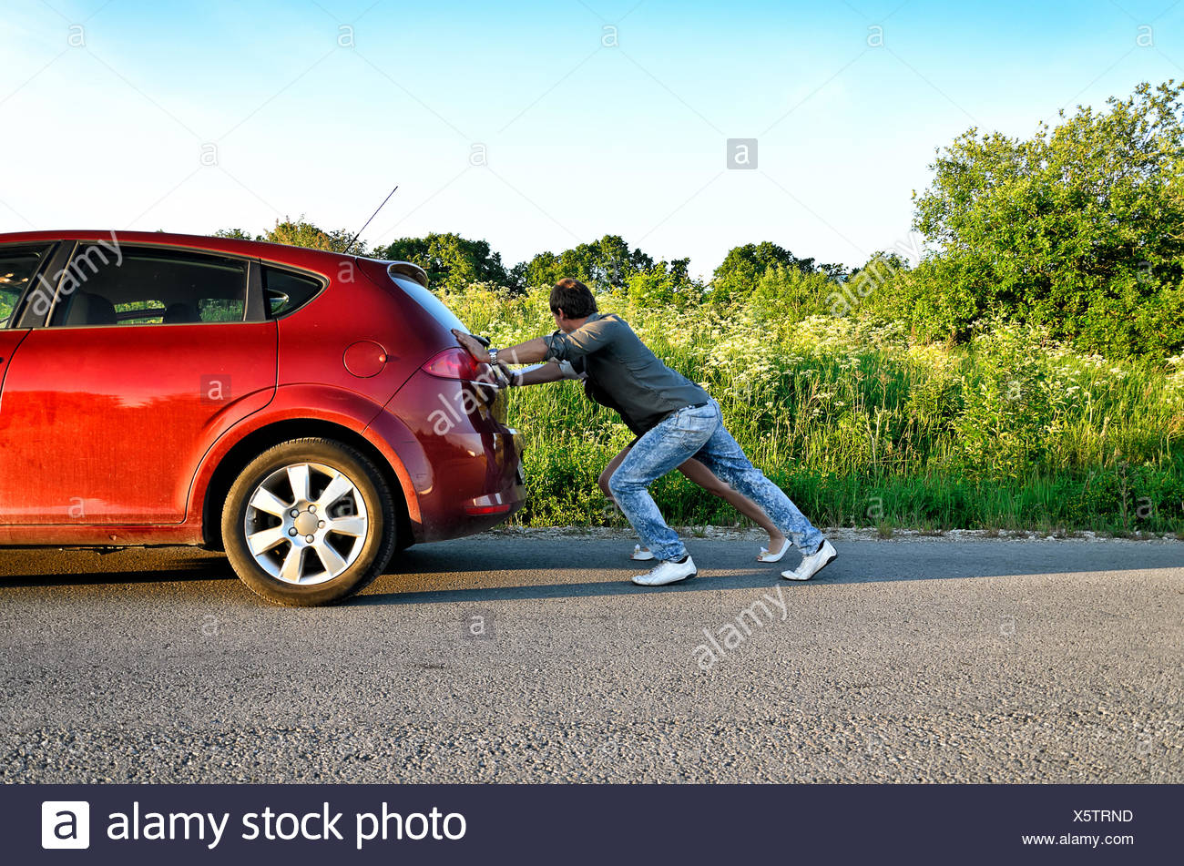 Mann Und Frau Ein Kaputtes Auto Schieben Stockfotografie Alamy