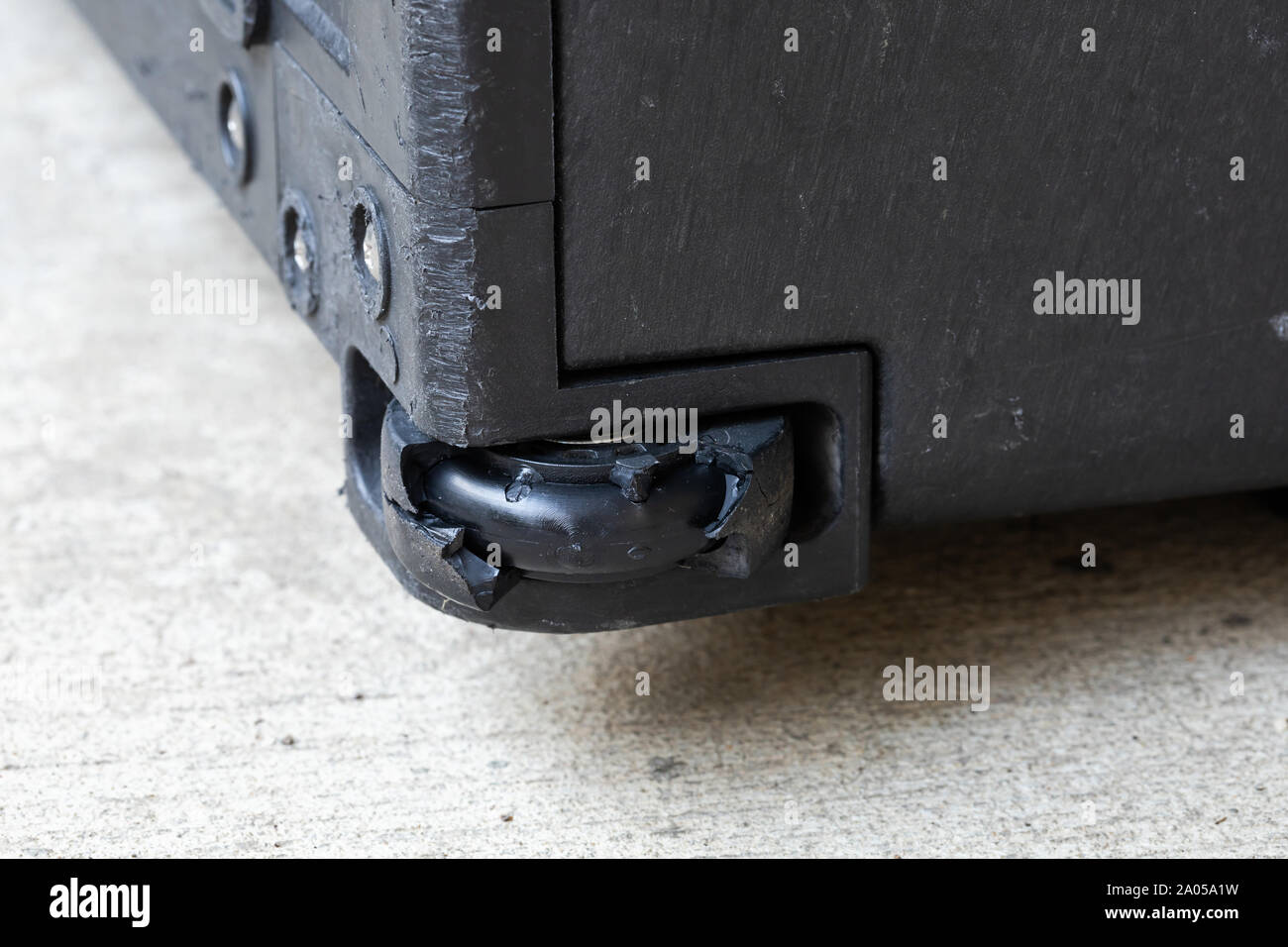 Cerrar agrietado roto dañado caducado arruinado desgarrado cojinete de  caucho caja rígida maleta equipaje necesario sustituir la rueda para reparar  o arreglar el problema Fotografía de stock - Alamy