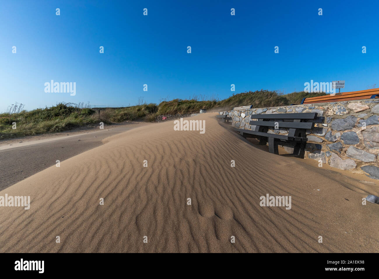 El viento sopla la arena de la playa cubre asientos de plástico reciclado bancos en una nueva duna. Port Eynon, Gower, AONB, Swansea, Gales, la Península de Gower, Foto de stock