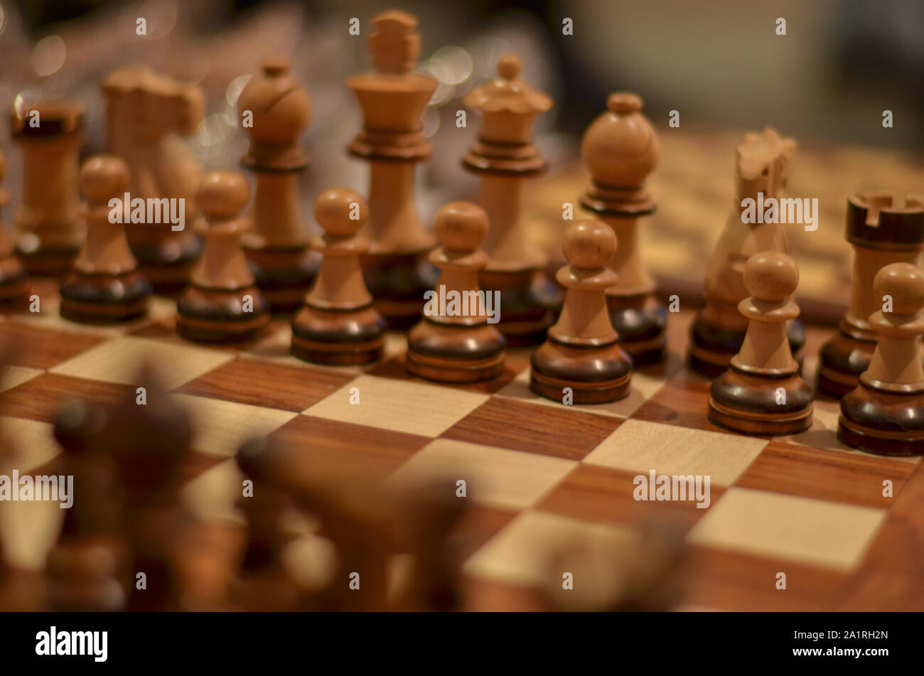 Primer plano de un tablero de ajedrez de madera. El ajedrez es un juego de  mesa de estrategia para dos jugadores juega en un tablero cuadriculado con  64 plazas Fotografía de stock -
