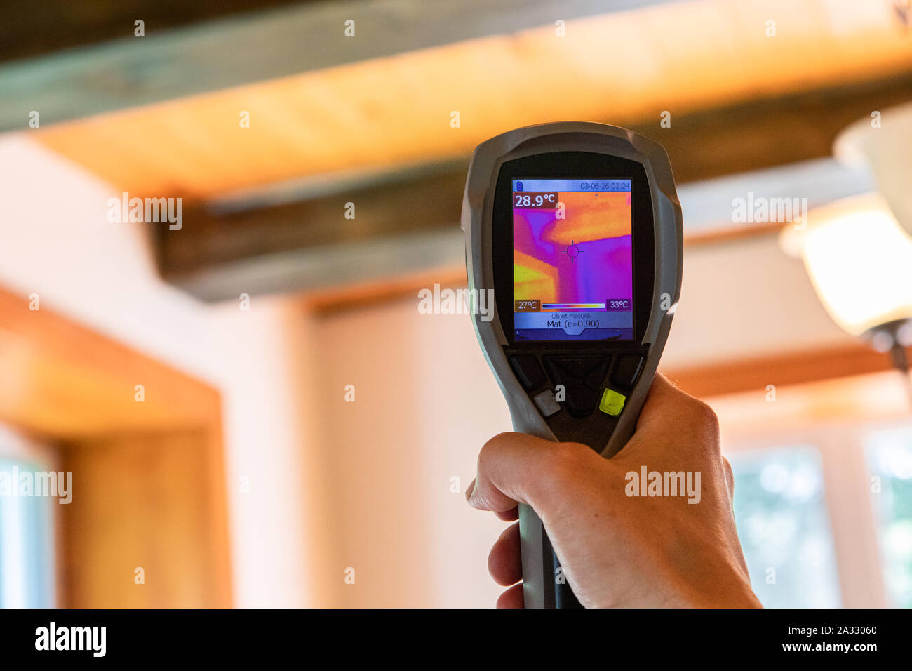 Un dispositivo de imagen térmica infrarroja es visto en uso, cierre durante una calidad ambiental interior y el reglamento de evaluación, con espacio de copia. Foto de stock