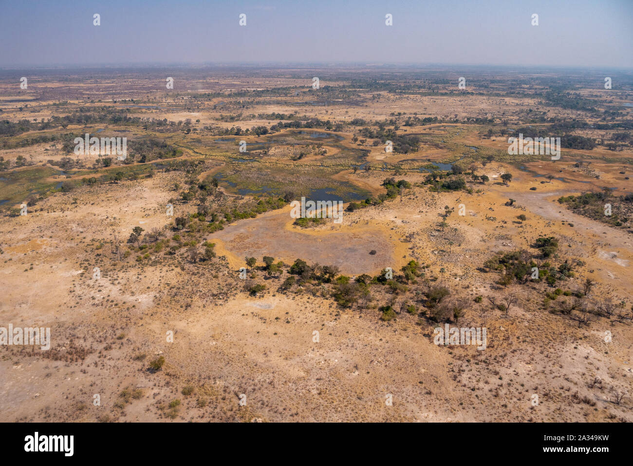 Vista aérea del paisaje del Delta del Okavango en temporada seca con la sabana, árboles y arroyos Foto de stock