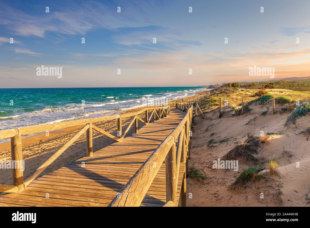 Paisaje de pasarela de madera para acceder a la playa en verano . Guardamar, Alicante, España Foto de stock