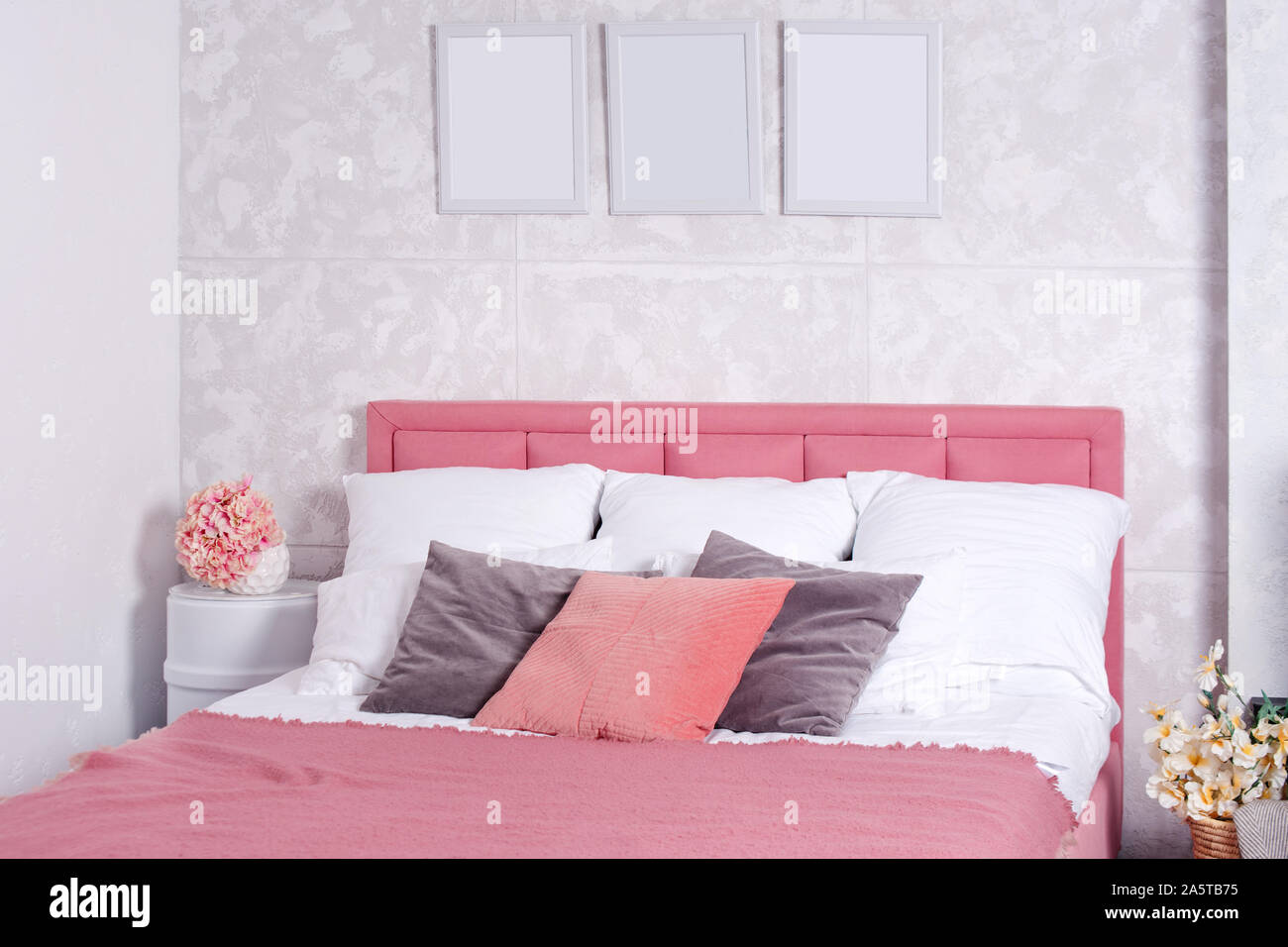 Interior elegante dormitorio moderno. Blanco y rosa de diseño acogedor  dormitorio con flores. Cama king-size con ropa de cama rosa y gris  Fotografía de stock - Alamy