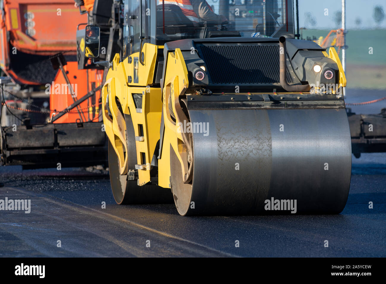 Un rodillo de compactación en una carretera de asfalto Fotografía de stock  - Alamy
