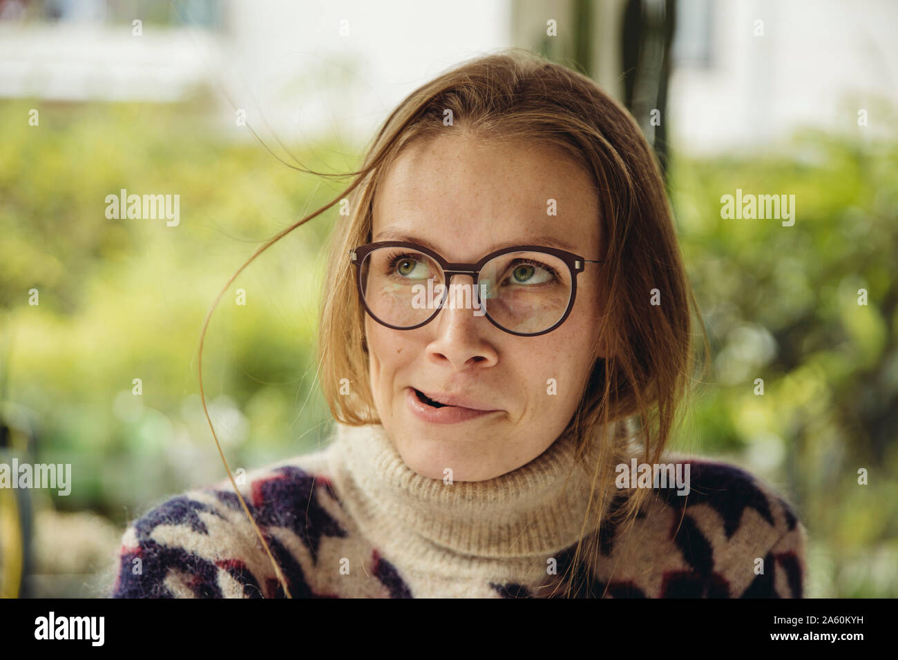 Retrato de mujer joven con gafas volaron un suéter esponjoso cabello Foto de stock