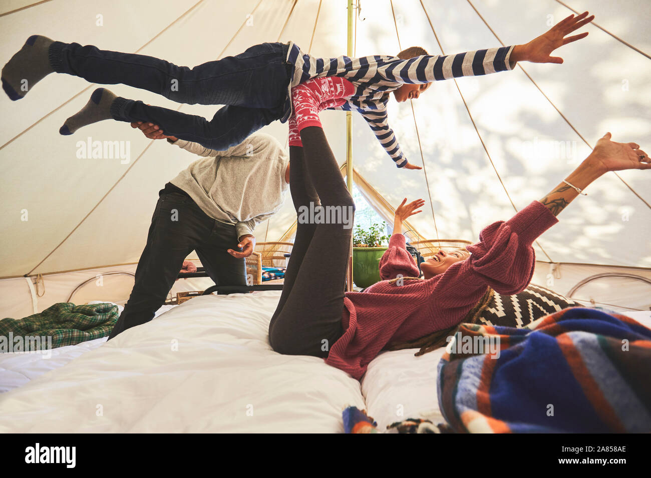 Familia juguetona en camping yurt Foto de stock