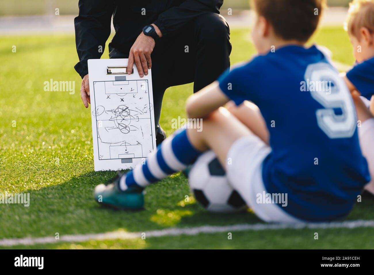 Reunión del equipo de fútbol. Entrenador de Fútbol dando consejos táctica  utilizando una pizarra blanca. Entrenador del equipo juvenil de deportes  Fotografía de stock - Alamy