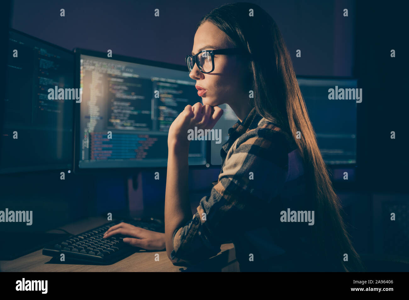 El perfil lateral foto de adivinar el pensamiento inteligente mujer que trabaja en el turno nocturno en lugar de su colega, el administrador del sistema Foto de stock