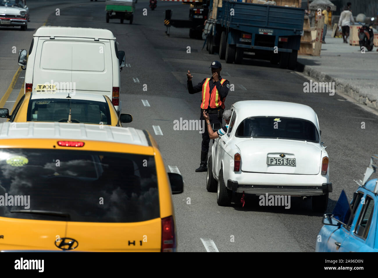 El tráfico se desvió por la policía de tráfico de La Habana, vestido con su chaleco de alta visibilidad en el Malecón, La Habana, Cuba. Foto de stock