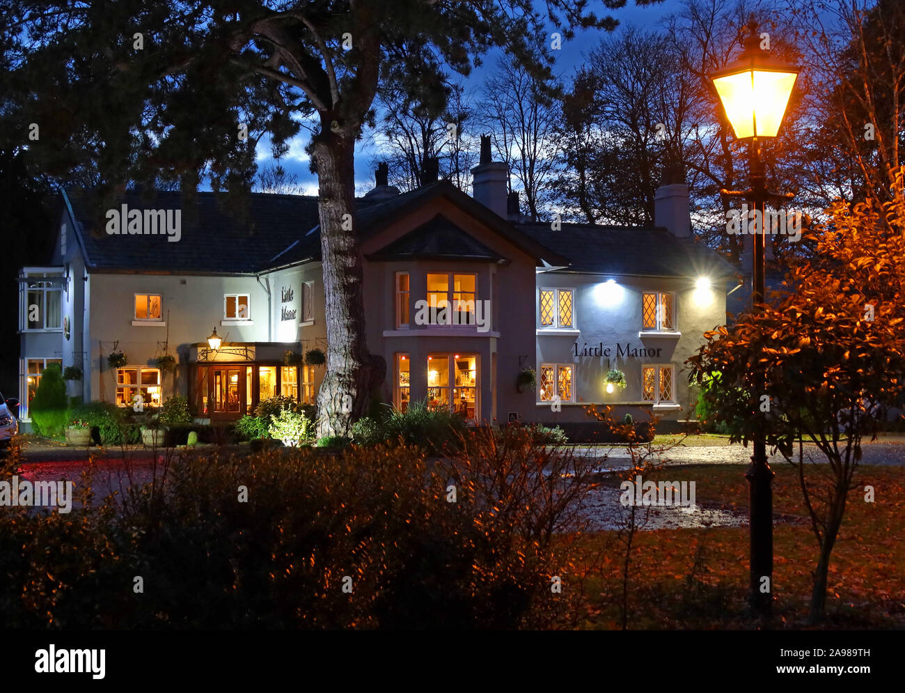 El pequeño Manor, Pub en la noche, Bell Lane, Thelwall, Sur en Warrington, Cheshire, al Noroeste de Inglaterra - Brunning y precio - WA4 2SX Foto de stock