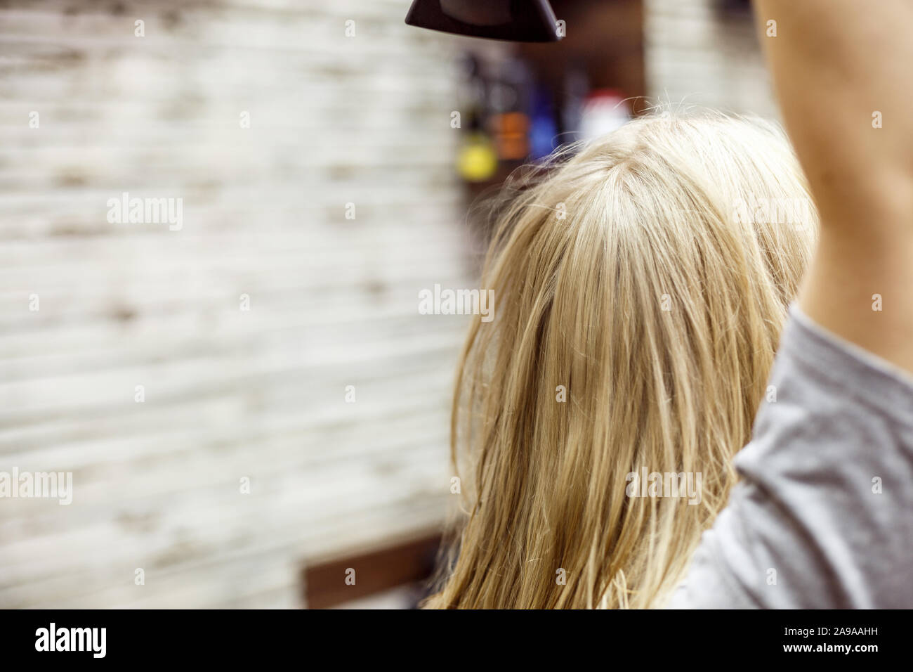 Mujer rubia no identificada se seca el cabello mojado con secador de pelo  Fotografía de stock - Alamy