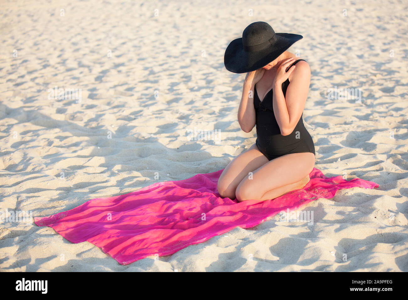 Agente de mudanzas El camarero cubierta Mujer con sombrero negro y traje de baño en la playa Fotografía de stock -  Alamy