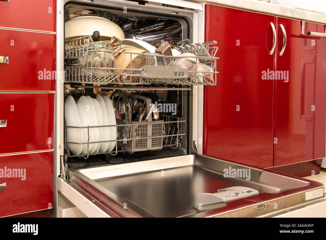 Limpiar platos recién lavada en el lavavajillas, rojo los armarios de la  cocina Fotografía de stock - Alamy