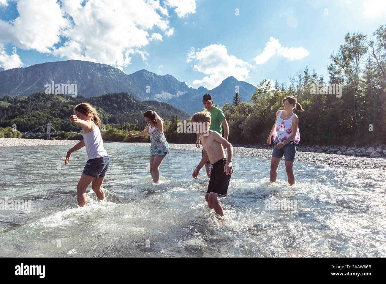 Familia cruzar el río Lech, Allgaeu, Reutte, Tirol, Austria Foto de stock