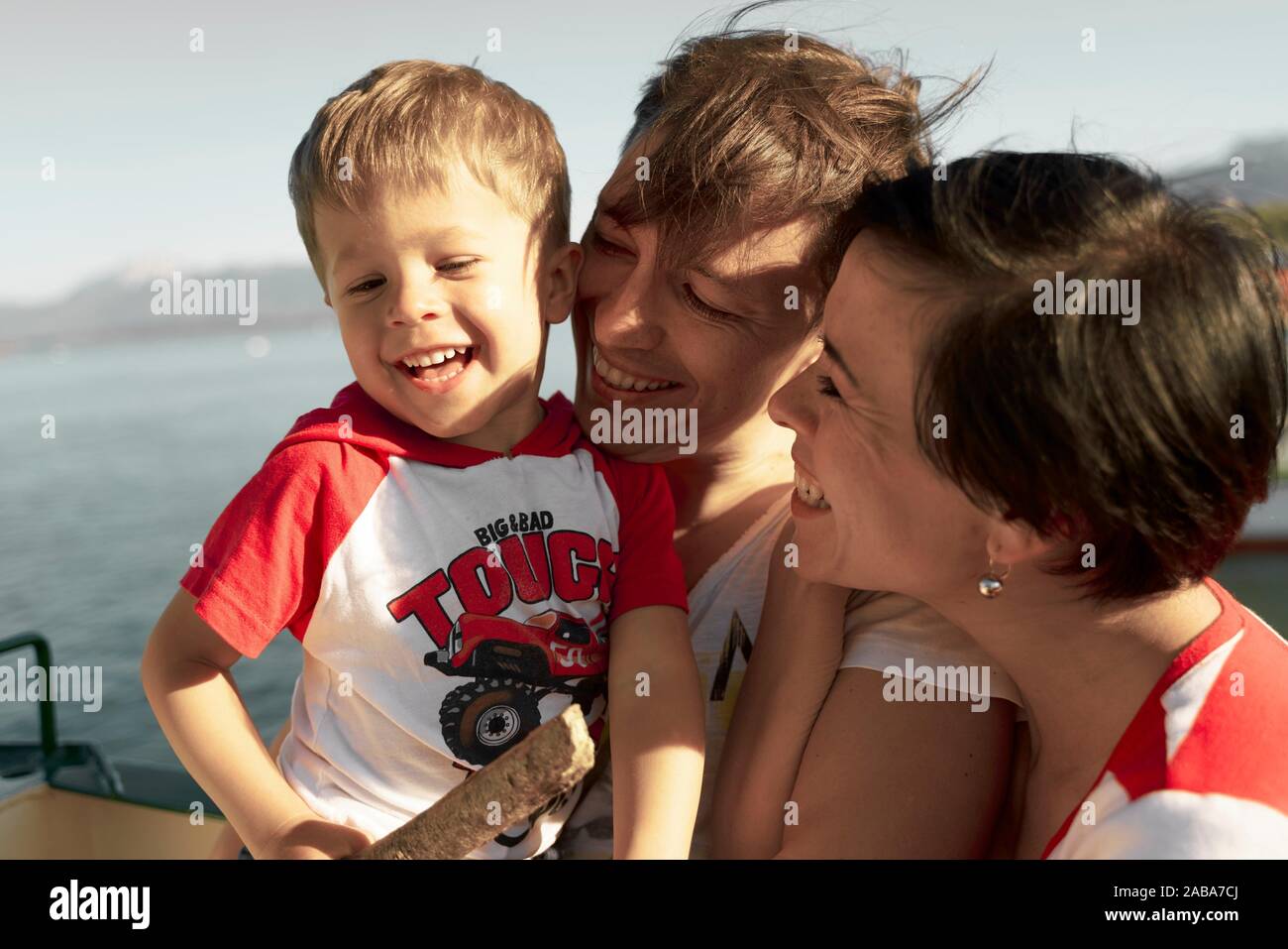 Felices padres con HIJO, NIÑO NIÑO, durante el día de viaje, una escapada familiar, en ferry en Chiemsee, Baviera, Alemania Foto de stock