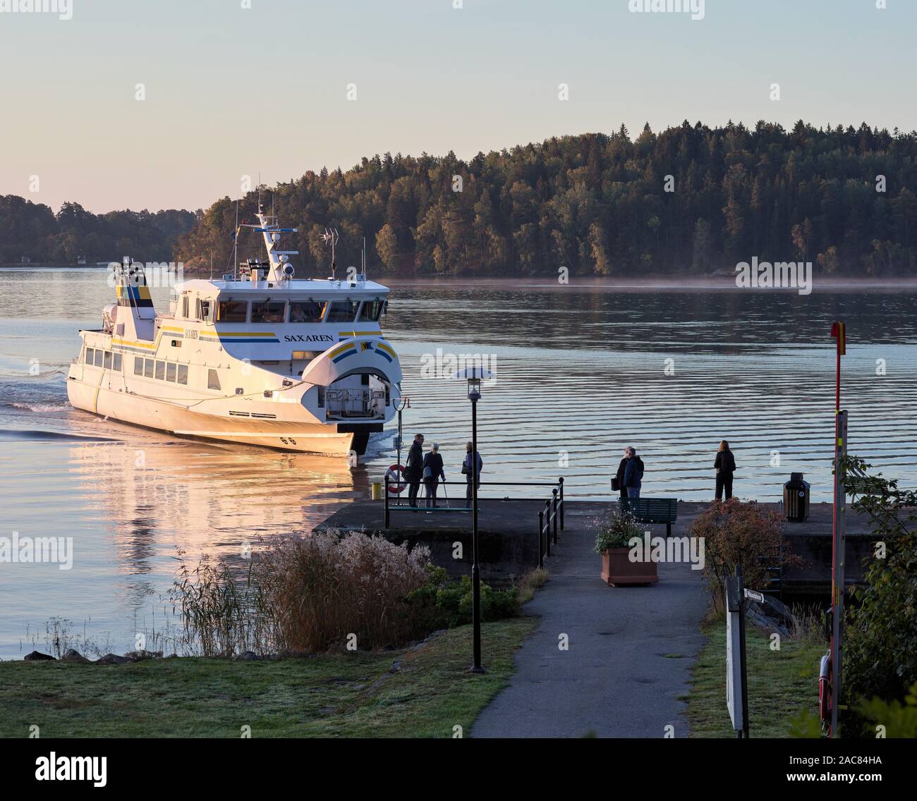 Barco Commuter Saxaren llegar al embarcadero de Frederiksberg en Vaxholm, Suecia Foto de stock
