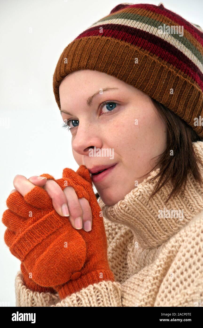 Gorro y guantes de invierno. Mujer vistiendo un gorro de punto y guantes  sin dedos para mantener el calor en clima frío Fotografía de stock - Alamy