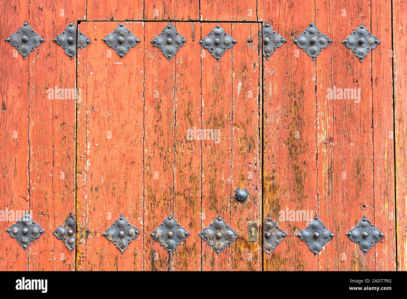 Fondo de una ornamentada puerta de madera naranja Foto de stock