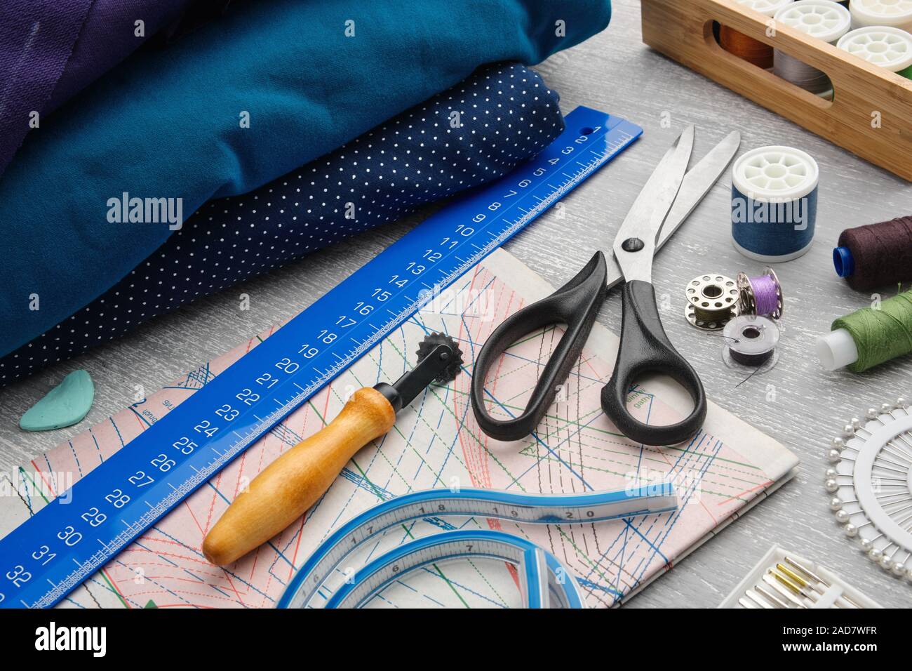 Artículos de costura: tijeras de costura; cinta métrica; dedal; carretes de  hilo, incluidos alfileres, agujas y accesorios de costura en tela de coser.  Vista desde arriba .: fotografía de stock © ChamilleWhite #302223408