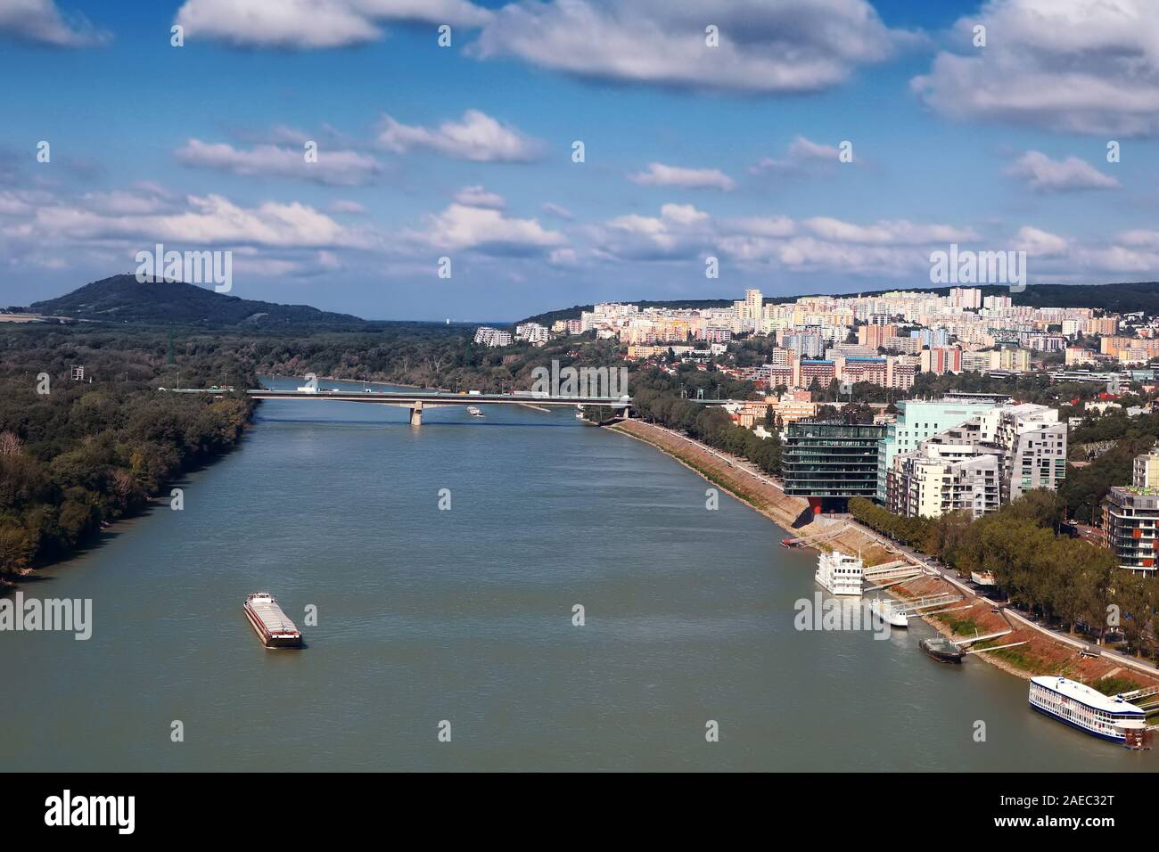 Vista del barco en el río Danubio, el puente Lafranconi y los edificios de nueva construcción en una zona residencial en Bratislava, Eslovaquia Foto de stock