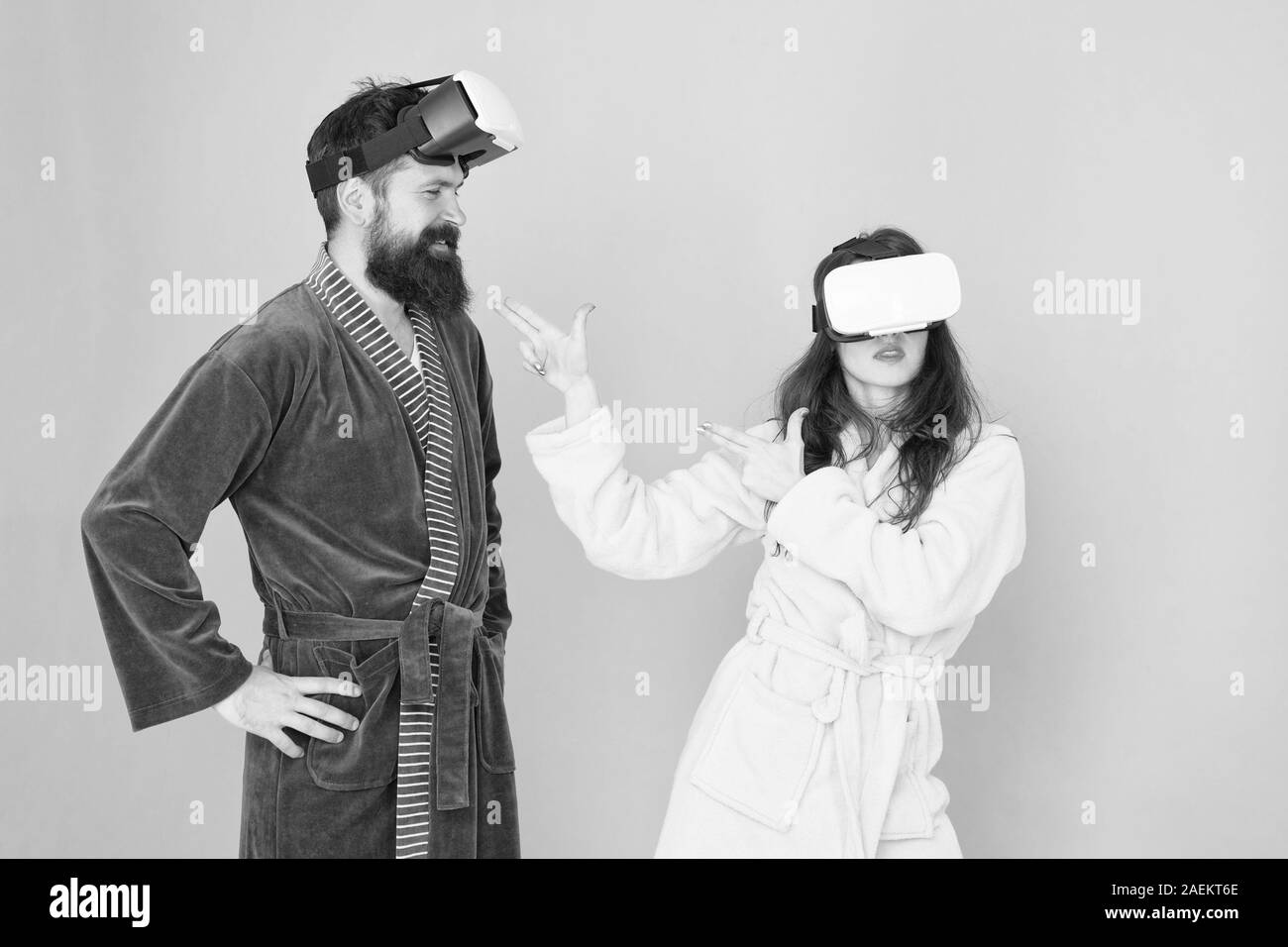 Crear tu realidad. mundo de immagination. Familia par llevar gafas vr. chica y man hipster relájese en albornoz. La mañana empieza con la tecnología del futuro. digital pareja. La innovación en las relaciones familiares. Foto de stock
