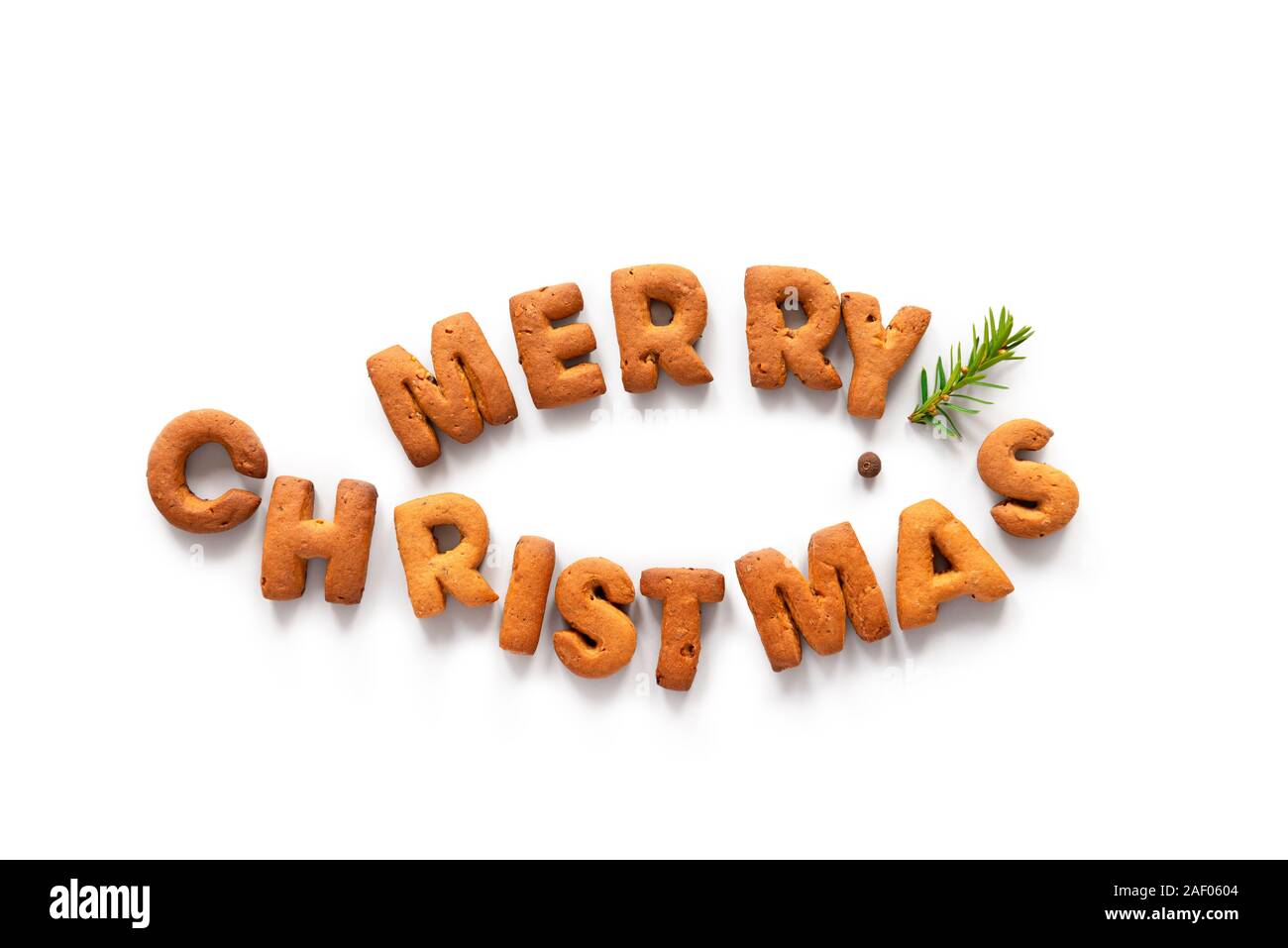 Gingerbread palabras Feliz Navidad apilados en forma de pez como un símbolo de la Cristiandad Foto de stock