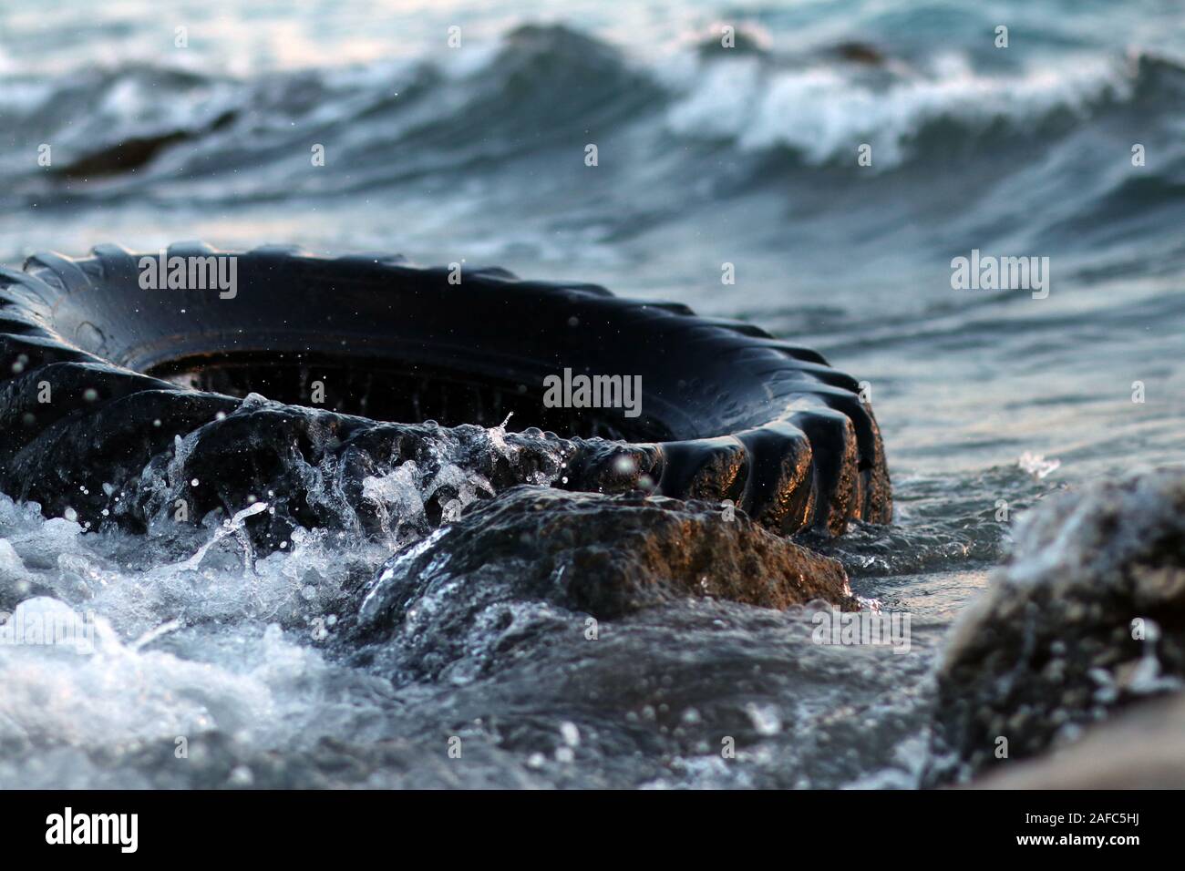 Neumático de coche flotando en el agua de mar Fotografía de stock - Alamy