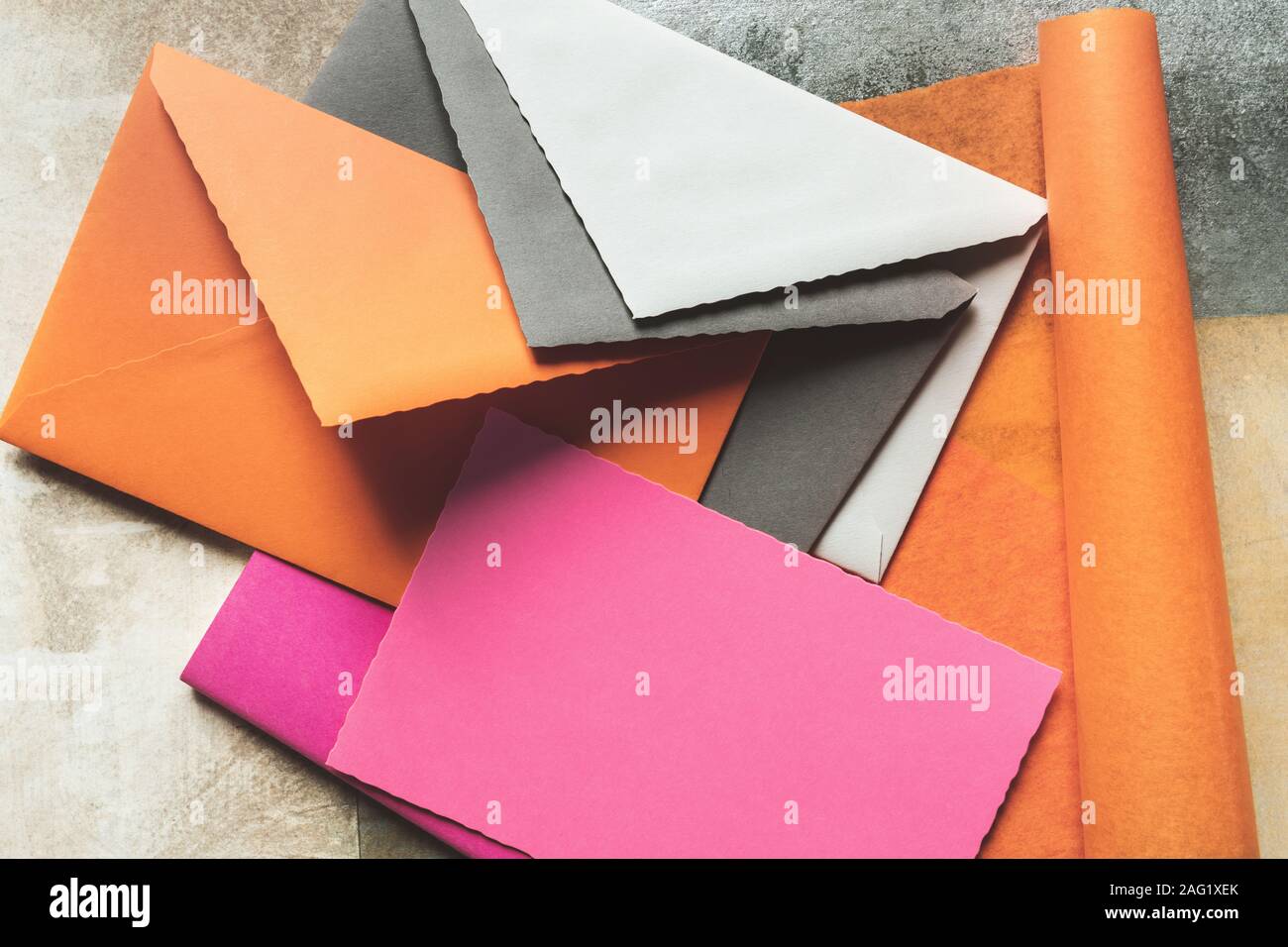 Varios sobres con coloridas tarjetas de felicitación, aislado sobre fondo grunge Foto de stock