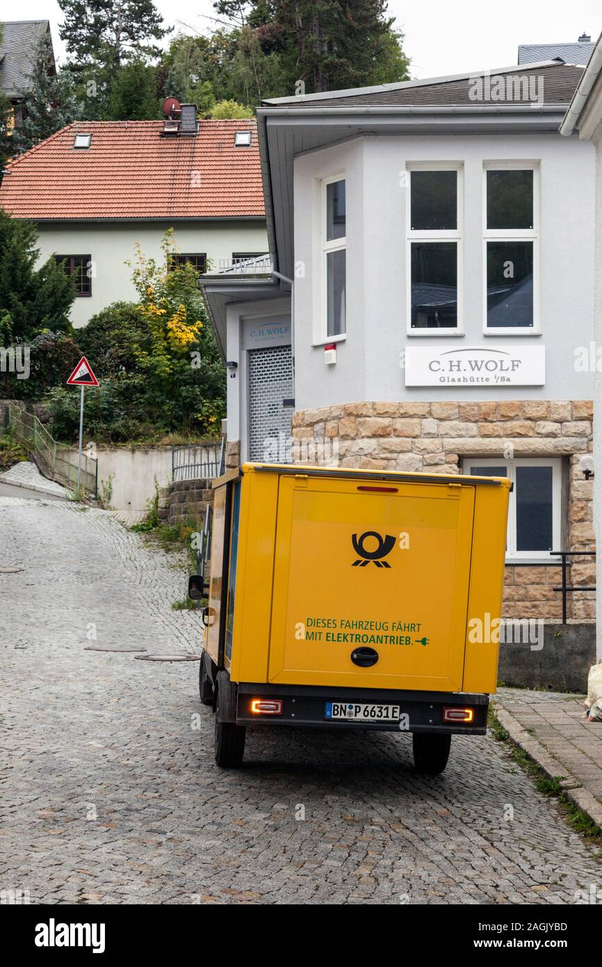 La entrega postal por el vehículo eléctrico en la zona montañosa en el Saxon Switzerland-Eastern Glashutte Montañas Ore district Foto de stock