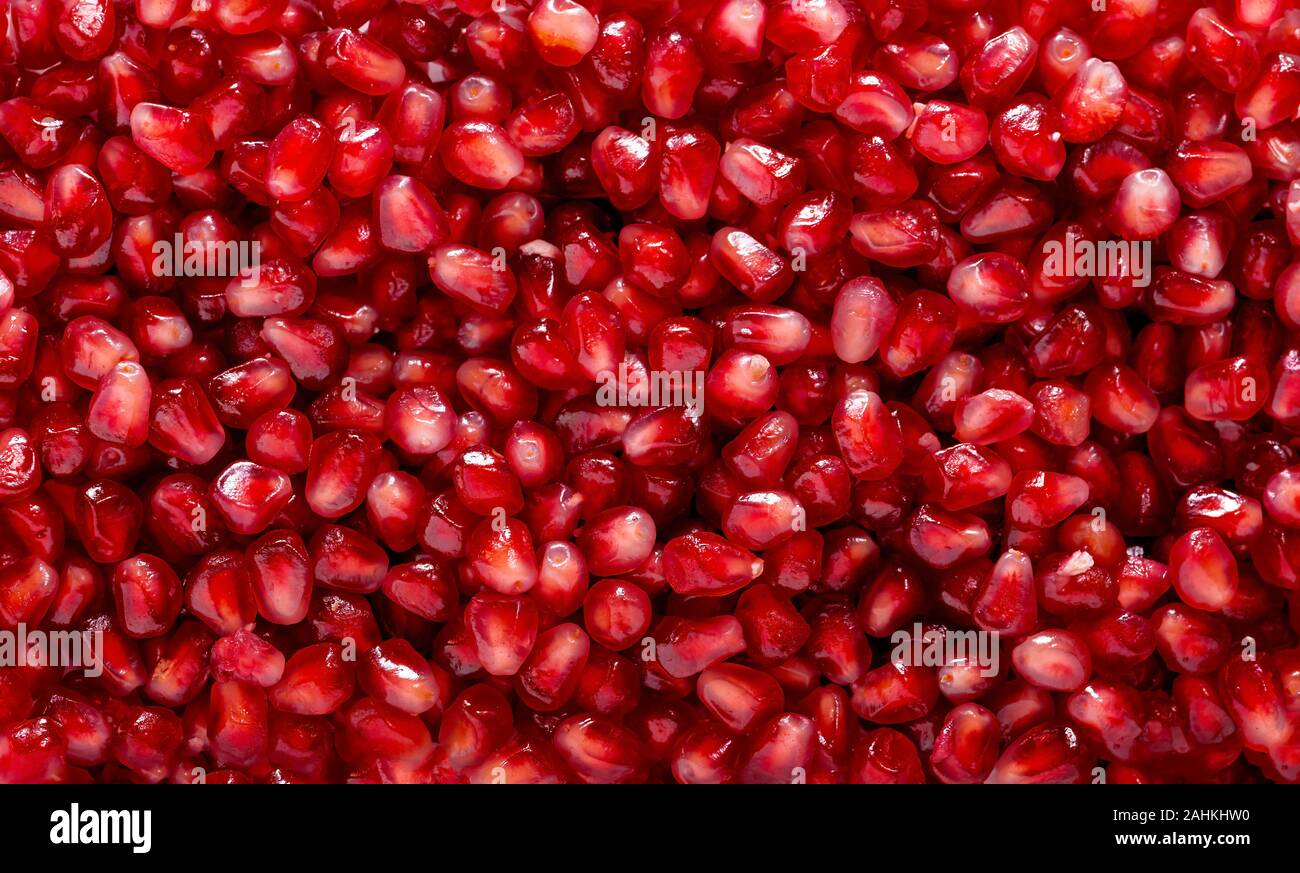 Semillas de Granada rojos frescos orgánicos de trama de fondo Foto de stock