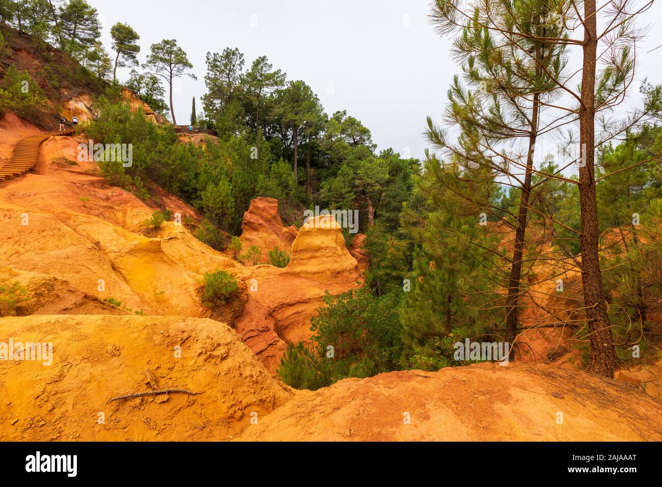 Sendero ocre en Roussillon, Sentier des ocres, ruta de senderismo en una colorida zona natural de acantilados rojos y amarillos en una cantera de pigmento ocre en desuso surrou Foto de stock