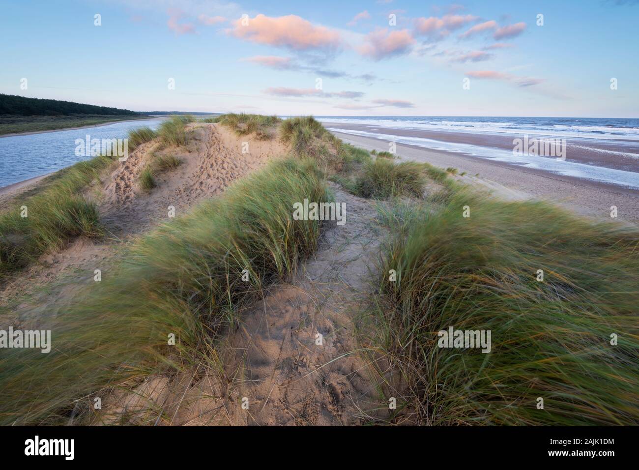 Amanecer sobre las dunas de arena de Wells junto a la playa del mar en marea alta, Wells-next-the-sea, Norfolk, Inglaterra, Reino Unido, Europa Foto de stock