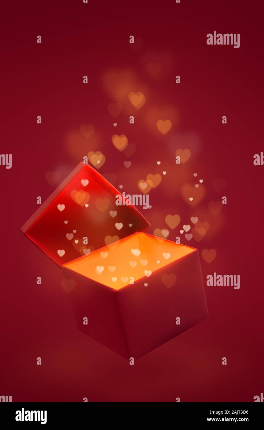 Caja mágica con amor regalo para el día de San Valentín, rosa roja brillar  con luz desde el interior con bokeh corazones Fotografía de stock - Alamy