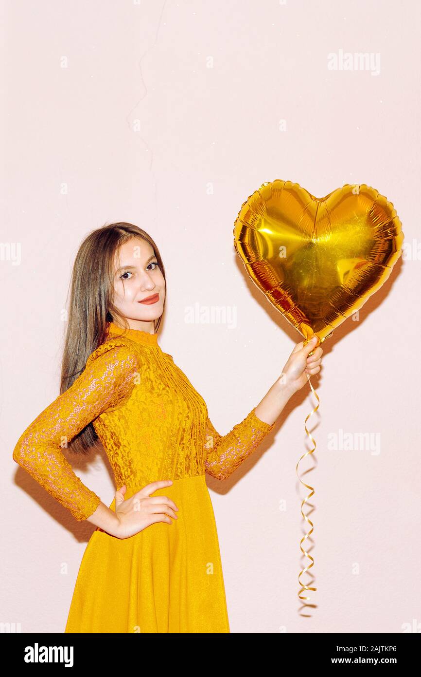 Hermosa Mujer De Vestido Amarillo Tiene Forma De Corazon Globo De Oro Dia De San Valentin Cumpleanos Dia De Las Mujeres Aniversario Celebracion Navidena Concepto Fotografia De Stock Alamy