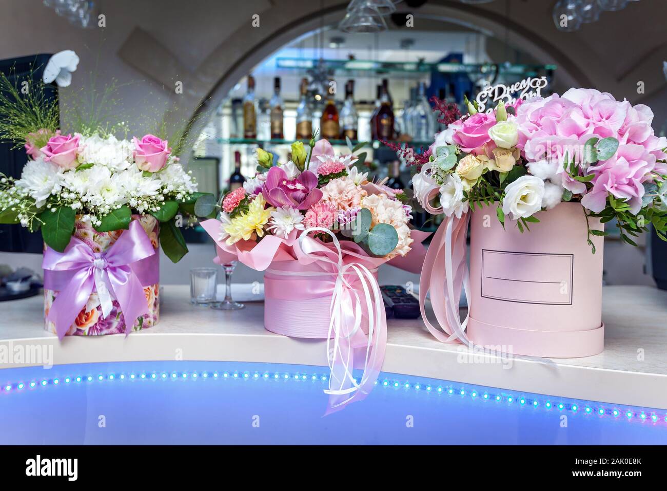 Hermosos arreglos florales con rosas en cajas de lujo decorado rosa cintas  se colocan en un bar Fotografía de stock - Alamy