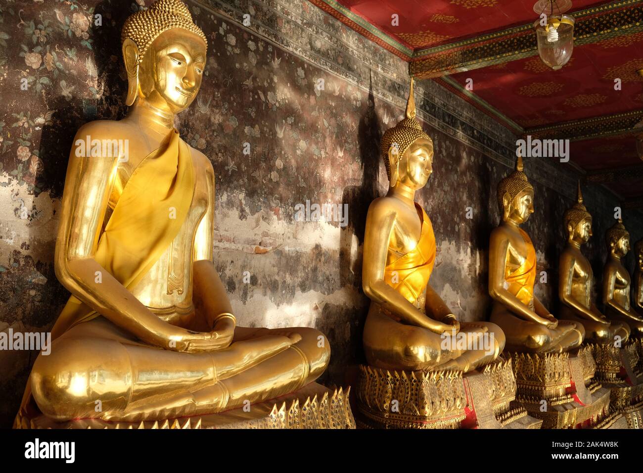 Bangkok, Tailandia Wat Suthat Thepwararam - meditando estatuas de Buda de oro al amanecer. Foto de stock