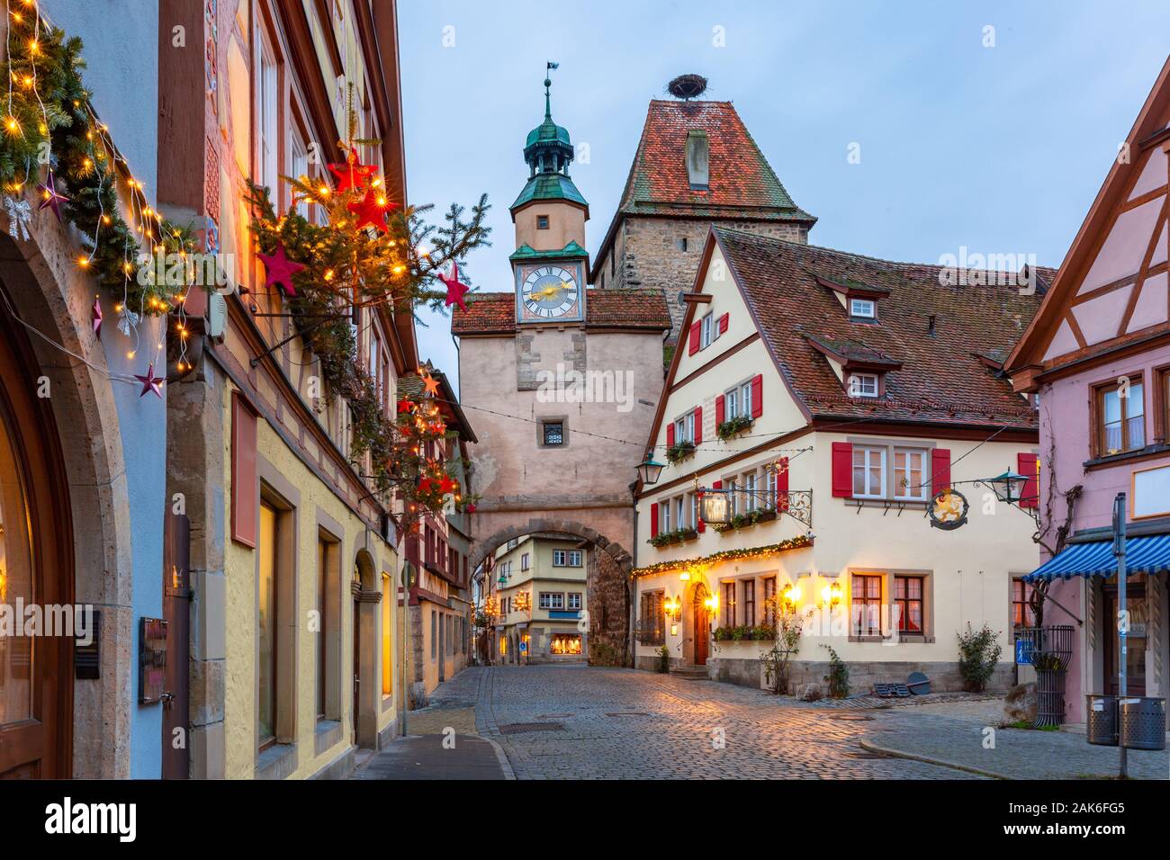 La calle de Navidad iluminado y decorado con la puerta y la torre Markusturm en la antigua ciudad medieval de Rothenburg ob der Tauber, Baviera, Alemania del sur Foto de stock