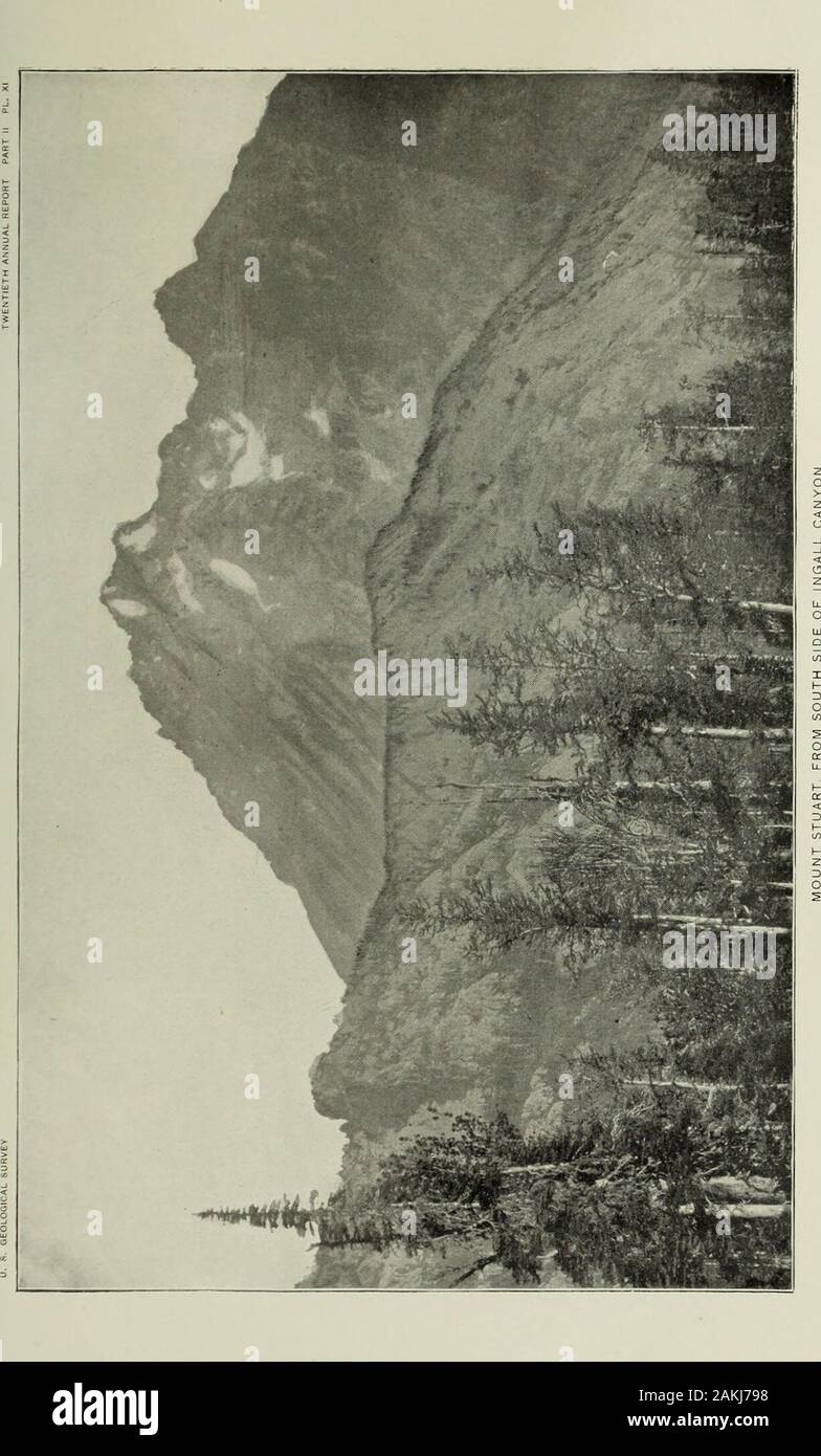 Informe anual del Servicio Geológico de los Estados Unidos al Secretario del Interior . dado clastic material del cual una basal conglom-erate está formado. El granito haría un buen edificio de piedra, y está libre de ironP3?ritos u otros minerales que puede esperarse que decomposereadily y causar manchas. No es atravesada por vetas de minerales andholds sin alicientes para el prospector. En algunos lugares, como nearLeavenworth, está cortado por estrechos diques básicos, similar y probablybelonging a una serie de diques basálticas que atraviesa un neighboringarea terciario de arenisca. El núcleo graníticas Foto de stock