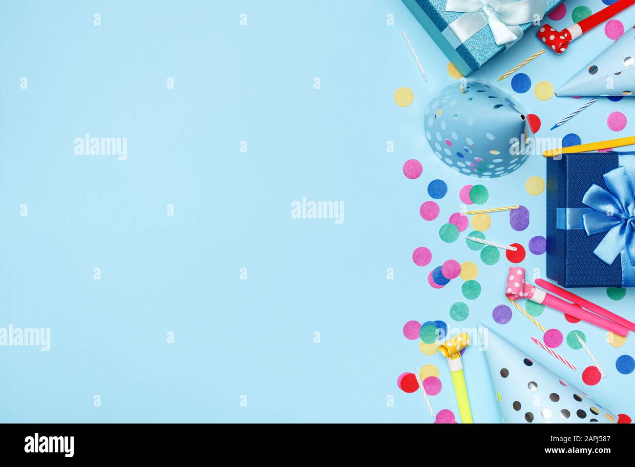 Cumpleaños azul fondo composición con fiesta tapas confetti velas copia espacio top vista plano laico. Foto de stock