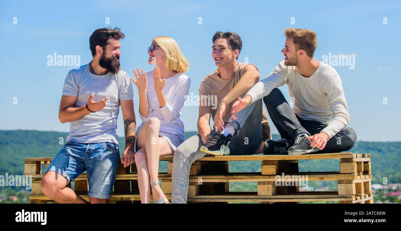 Descanso de verano. Pasar tiempo con amigos. Vacaciones de verano. Gente alegre que se comunica. Hombres y mujeres hablando de naturaleza de fondo. Jóvenes relajados. Ocio de verano. Concepto sin preocupaciones. Pase el rato juntos. Foto de stock