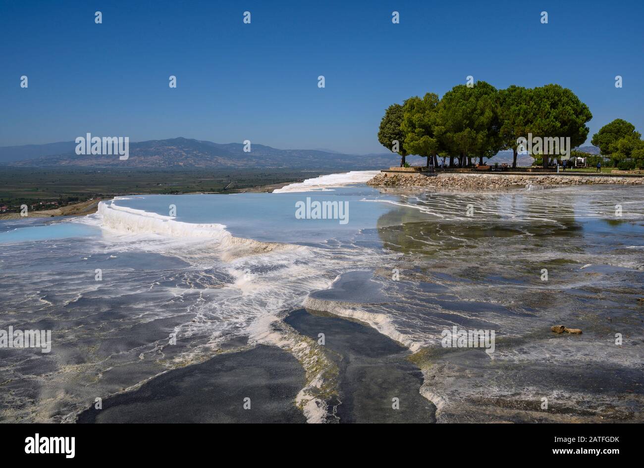 Aguas termales ricas en minerales que fluyen por terrazas travertinas en Pamukkale, Turquía Foto de stock