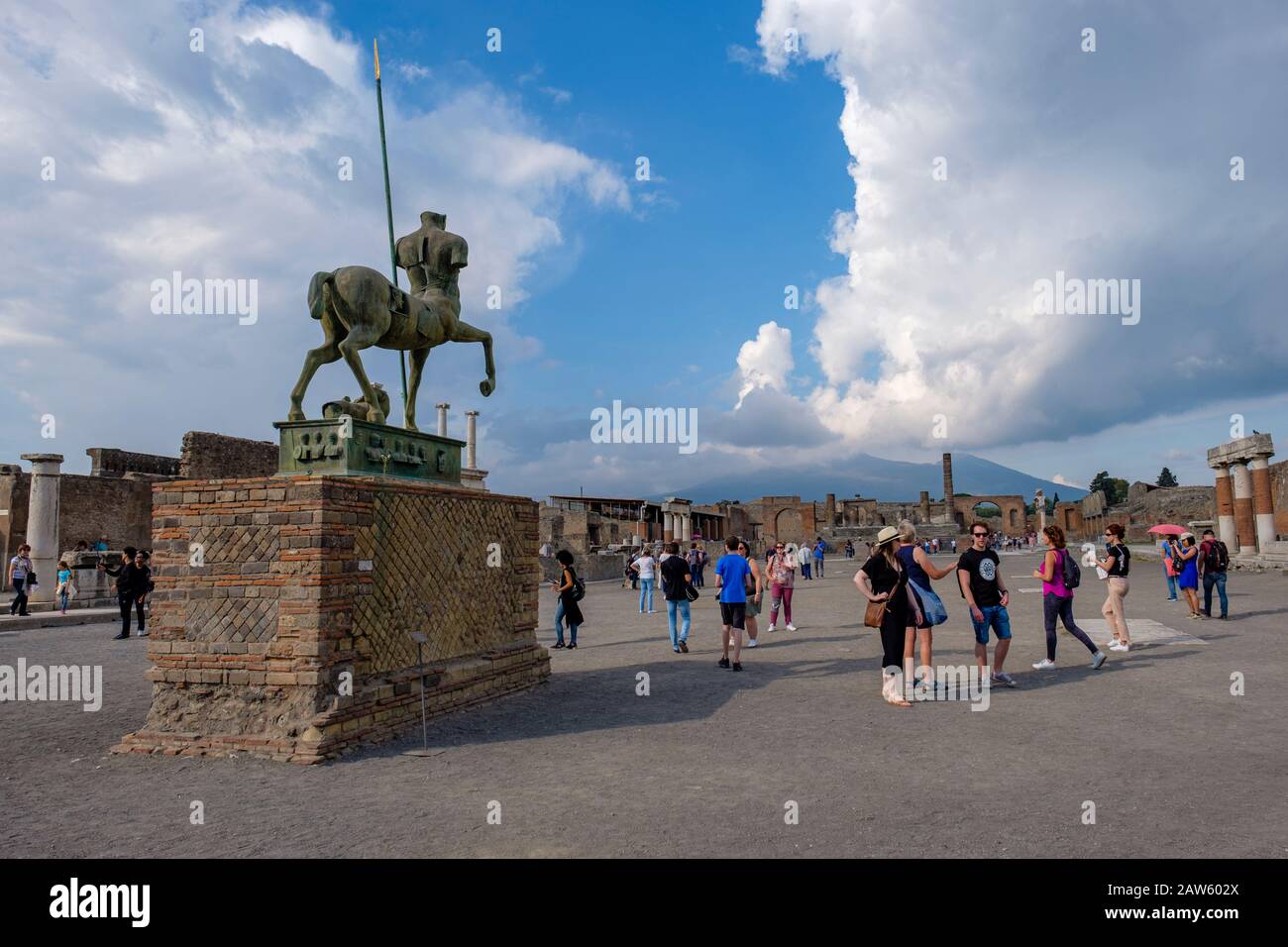 Ruinas de Pompeya, turistas que visitan Pompeya Forum - Centauro, estatua de bronce de Igor Motoraj, Monte Vesubio en el fondo, antigua ciudad de Pompeya, Italia Foto de stock