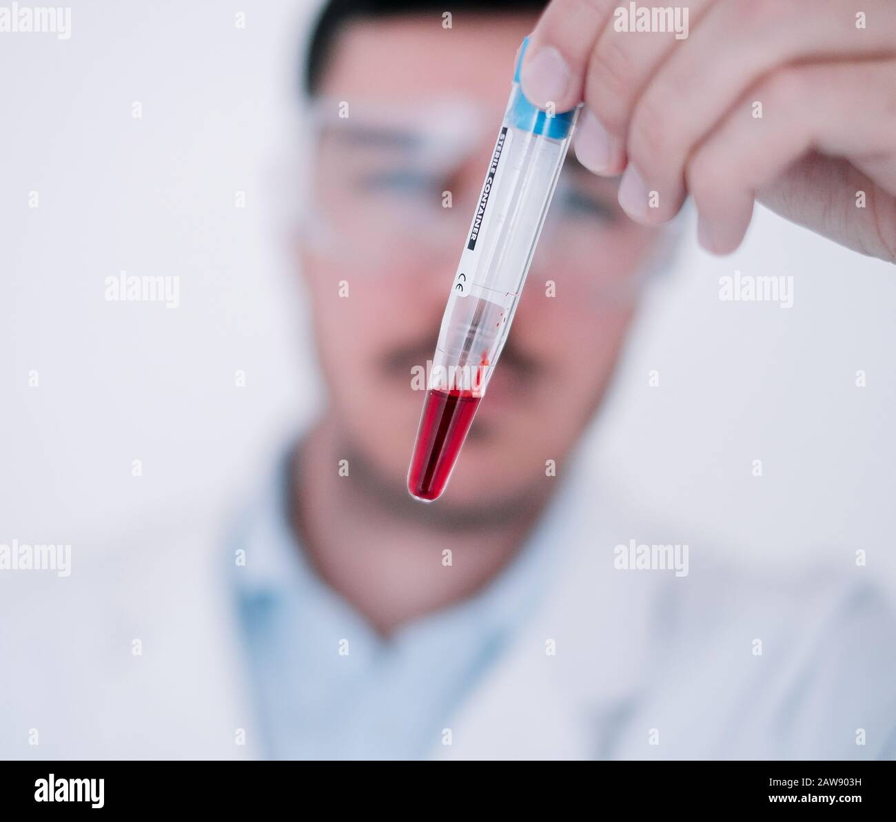 Un médico que realiza investigaciones médicas en un laboratorio con tubos de ensayo Foto de stock
