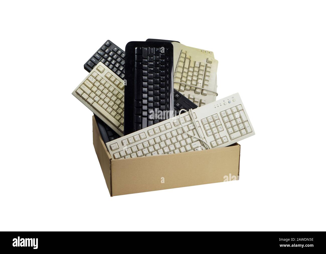 Basura electrónica. Caja de cartón llena de teclados de ordenador usados. Foto de stock