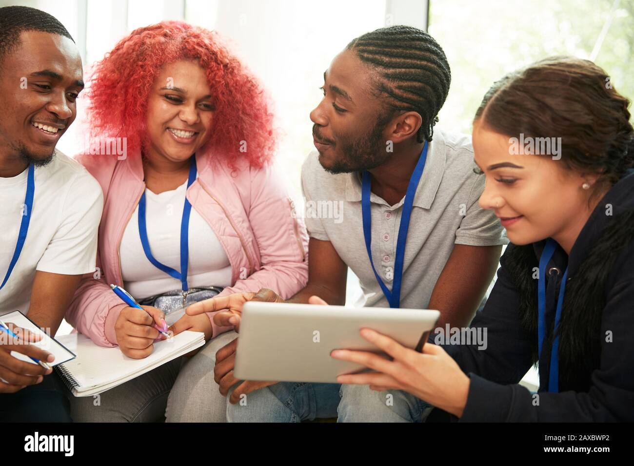 Felices estudiantes de secundaria con tableta digital estudiando Foto de stock