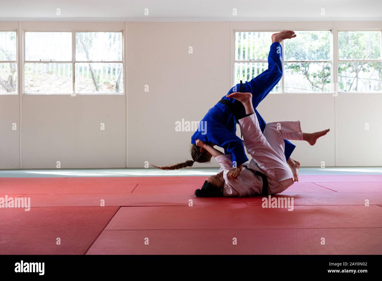 Judokas practicando judo durante un sparring en un gimnasio Foto de stock