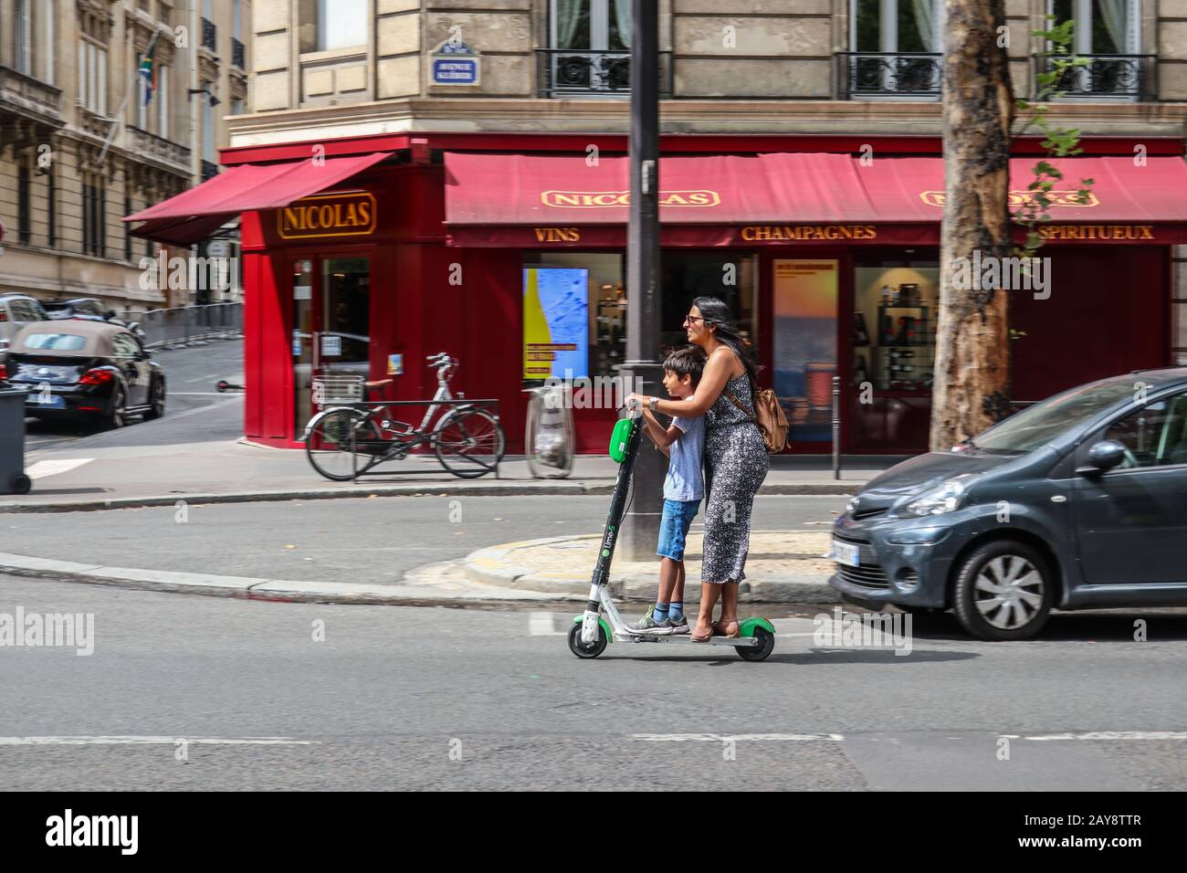 Mujer y niño Ride electric scooter en París, Francia Europa Foto de stock