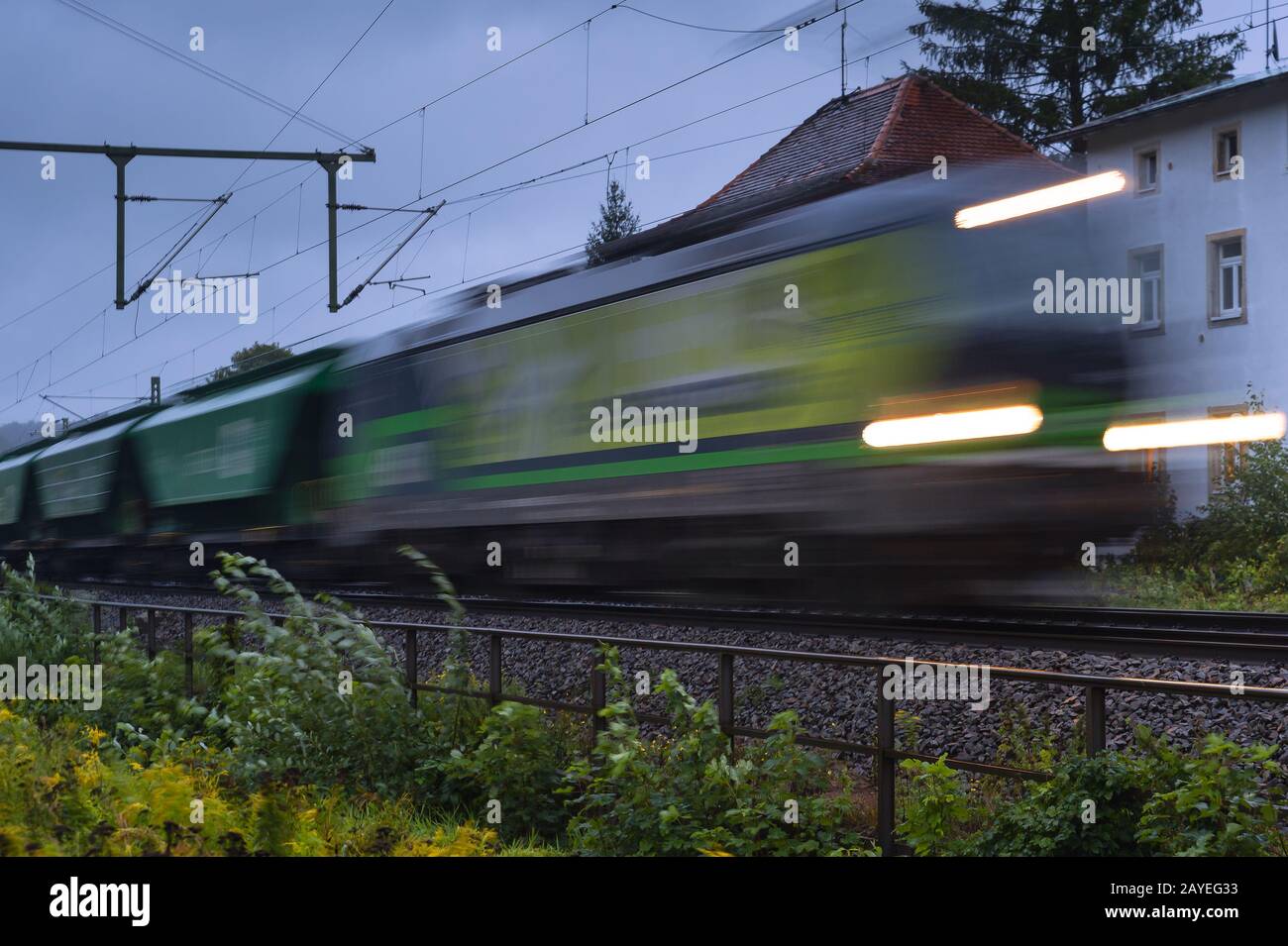 Tren de carga verde con desenfoque de movimiento Foto de stock