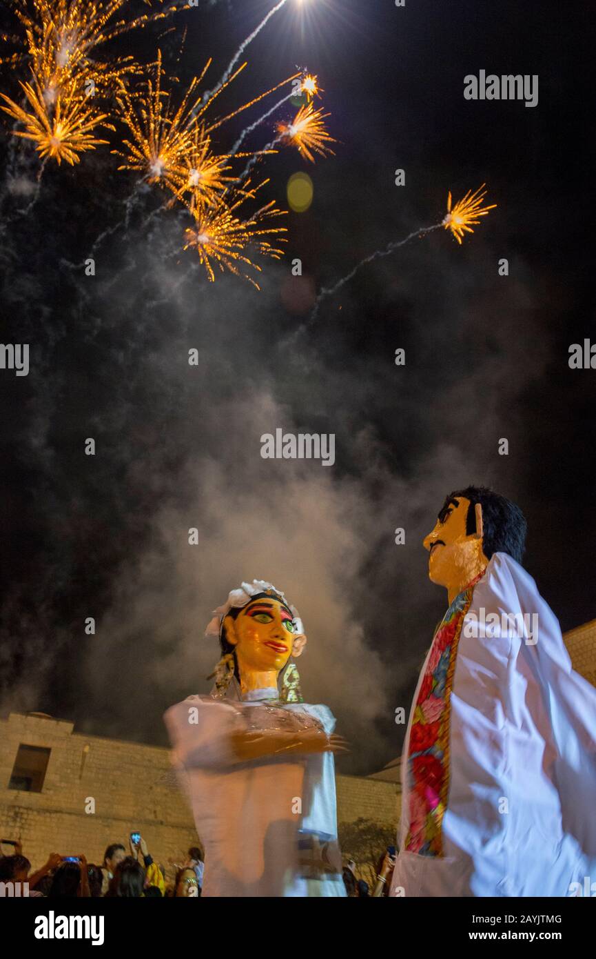 Fuegos artificiales y títeres gigantes vestidos como novia y novio durante  una Calenda, una procesión por las calles del centro de Oaxaca, celebrando  una boda Fotografía de stock - Alamy